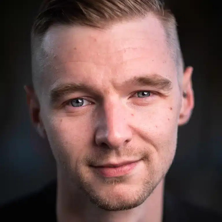 Headshot of Scottish Actor Dav, looking confident and assured to the the camera. He has deep grey eyes and stubble.