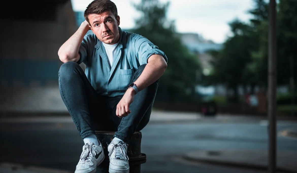 In one of my urban portrait shoots, Steven sits atop a bollard under the Kingston Bridge, Glasgow