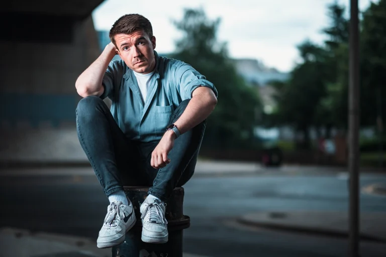 In one of my urban portrait shoots, Steven sits atop a bollard under the Kingston Bridge, Glasgow