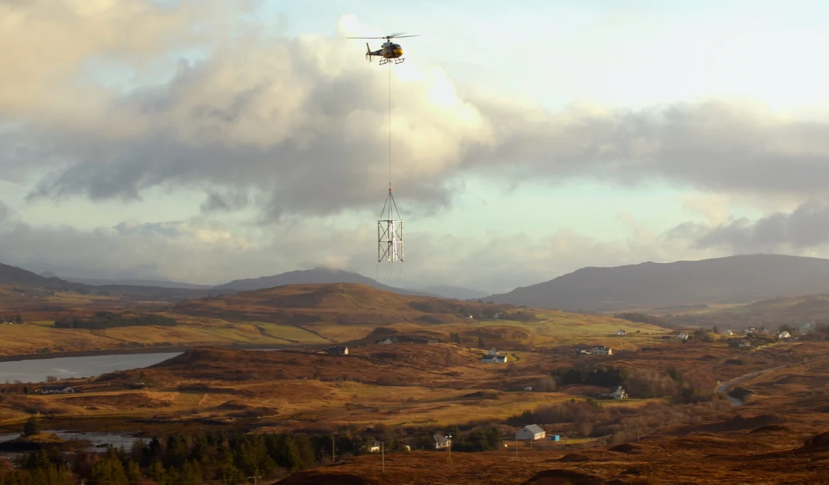 Skyhook helicopters fly a section of a mobile mast during construction work on behalf of Virgin Media O2.